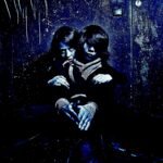 Two figures shrouded in darkness, sharing a secretive embrace illuminated by an eerie blue light.