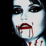 A heavily stylized and dramatic portrait of a person with vampire-themed makeup, featuring dark eyes, pale skin, and blood-like substance trickling from the mouth.