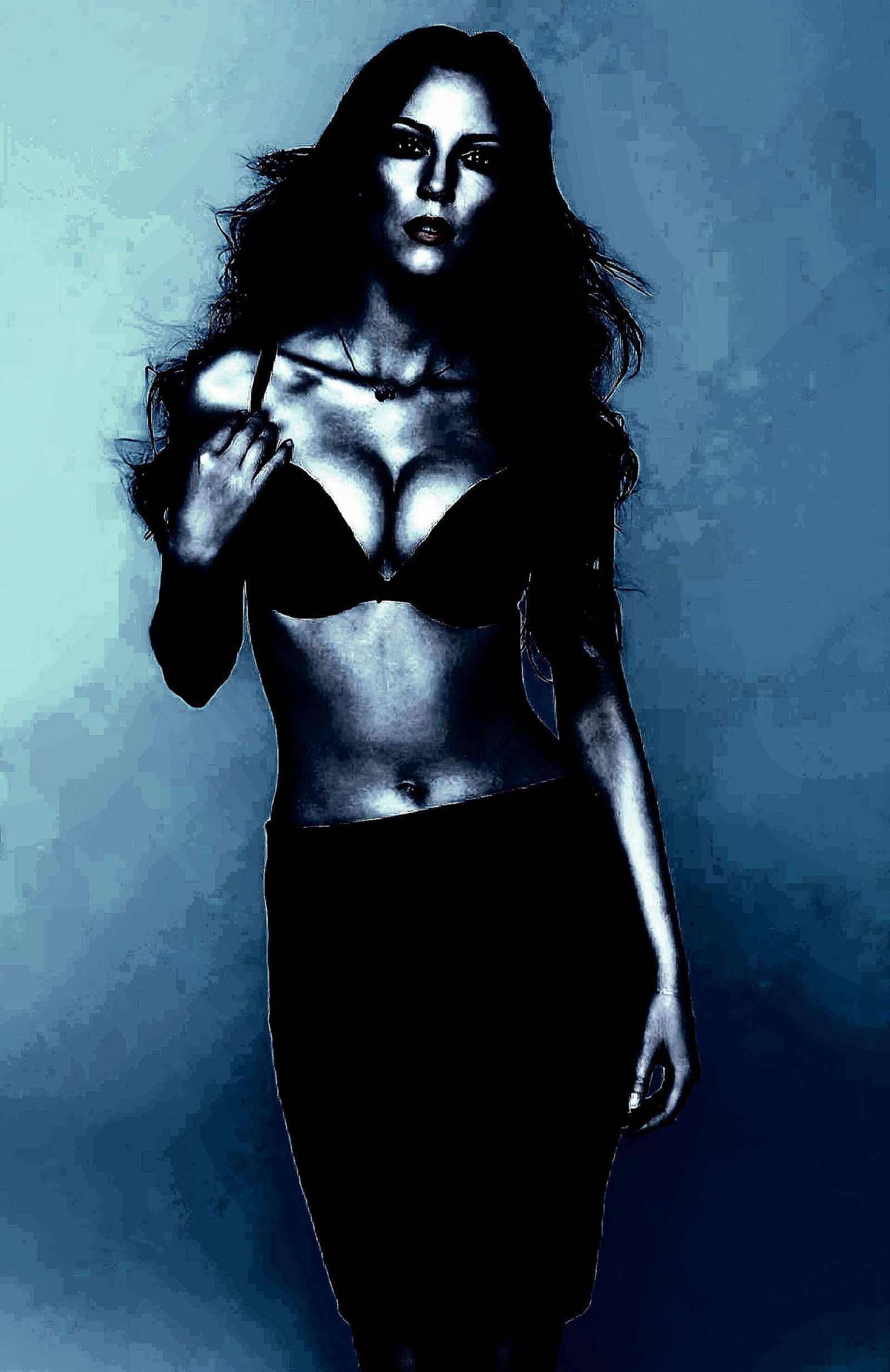 Woman with long hair in a black bra and skirt, posed with a confident gaze, emphasizing her bold and mysterious look.