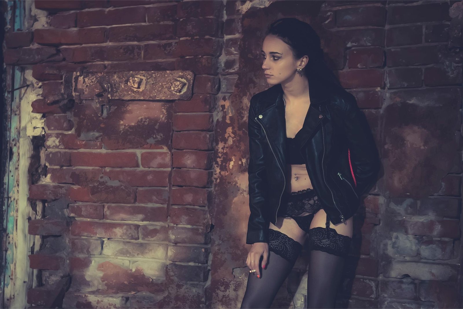 Woman in a black leather jacket and lace lingerie leaning against a rustic brick wall, gazing into the distance.
Close-up of a woman wearing a black leather jacket, mini skirt, and fishnet stockings, leaning against a wall.
Woman in black lace lingerie standing in a cozy bedroom with exposed brick walls, illuminated by warm lights.
Woman in black lingerie lying on a bed in a softly lit bedroom with exposed brick walls, looking at the camera.
Woman in black lace outfit standing in an underground parking lot, illuminated by car headlights in the background.
Woman in black sheer lingerie reclining on a bed, with a large mirror reflecting her in the background.
Woman in sunglasses holding a cocktail glass at a dimly lit bar, wearing red lipstick and a mysterious expression.
Woman in fishnet stockings and high heels leaning against a wall in a dimly lit urban tunnel, lost in thought.