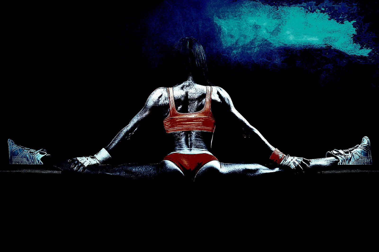 A woman in bright athletic wear performing a full split, highlighting her flexibility and muscular physique in dramatic lighting.
