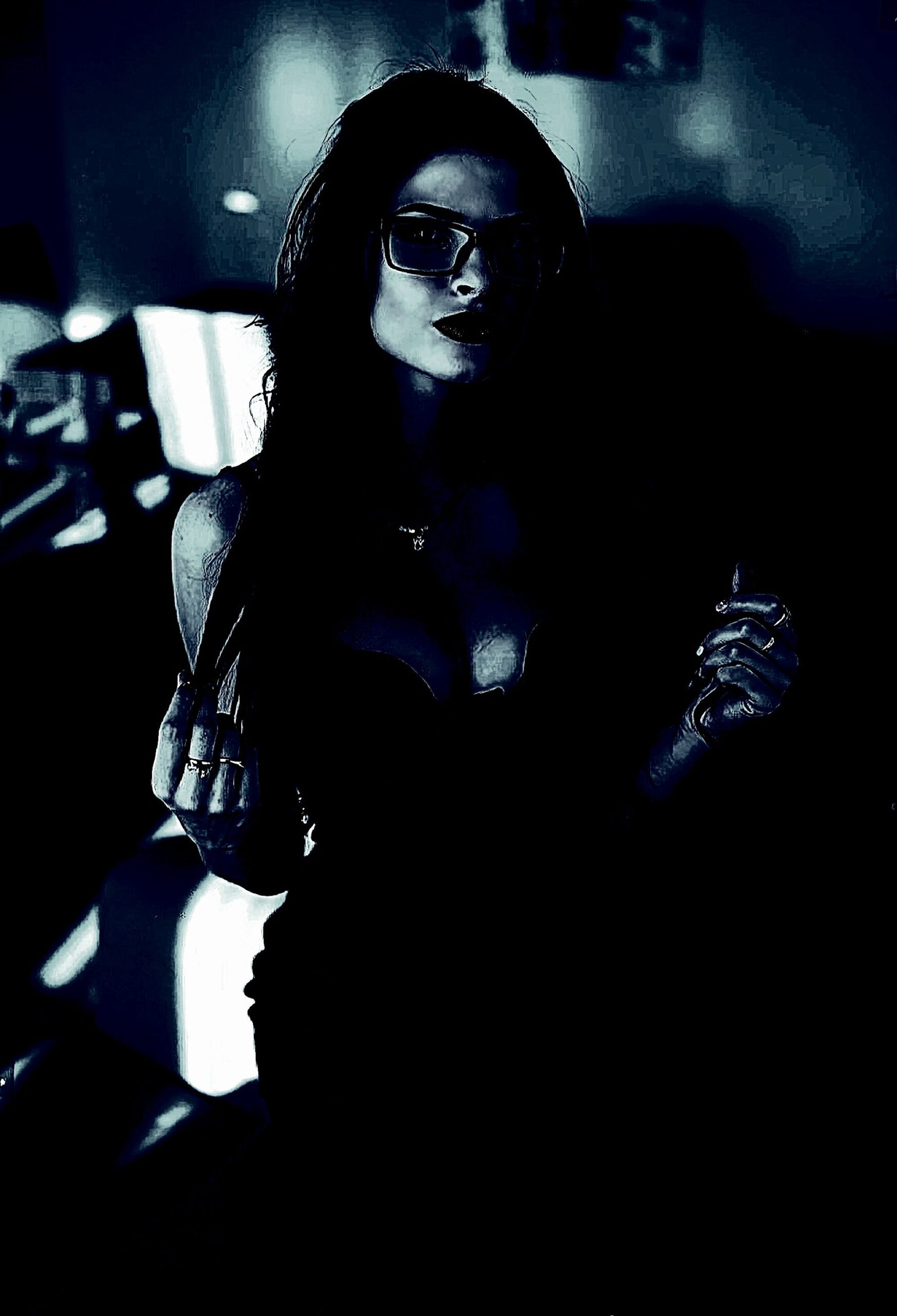 Goth-inspired individual embodying gender fluidity with dark attire and striking pose.