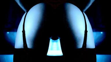 Erotic Symbolism and Imagery: Artistic shot of shadowed curves accentuated by blue backlighting with a mysterious gothic tone.