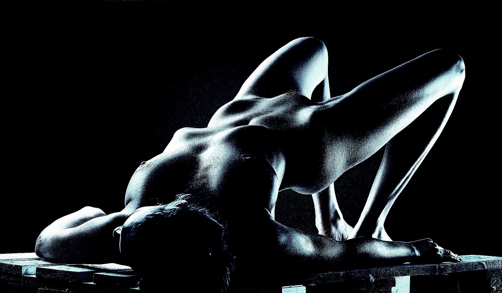 Abstract portrayal of a nude figure in shadow, focusing on form