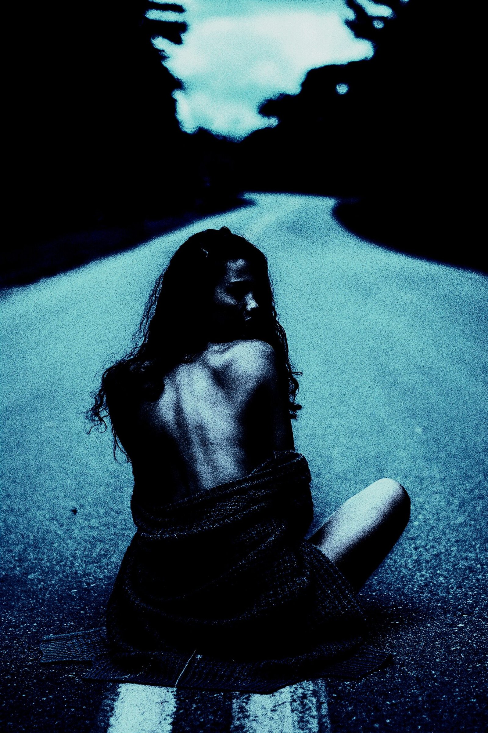 Lonely figure of a woman on an empty road, a symbolic 'red flags in a woman' scene of isolation.