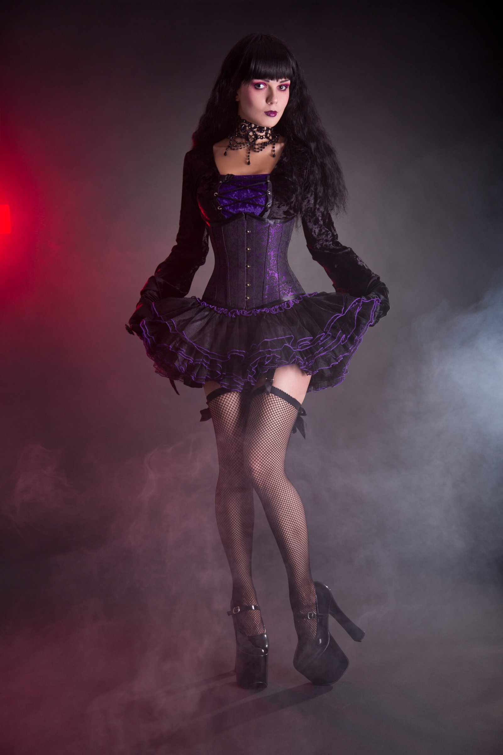 A poised woman in a dark velvet gothic corset dress with high platform heels, amidst a mysterious fog.
