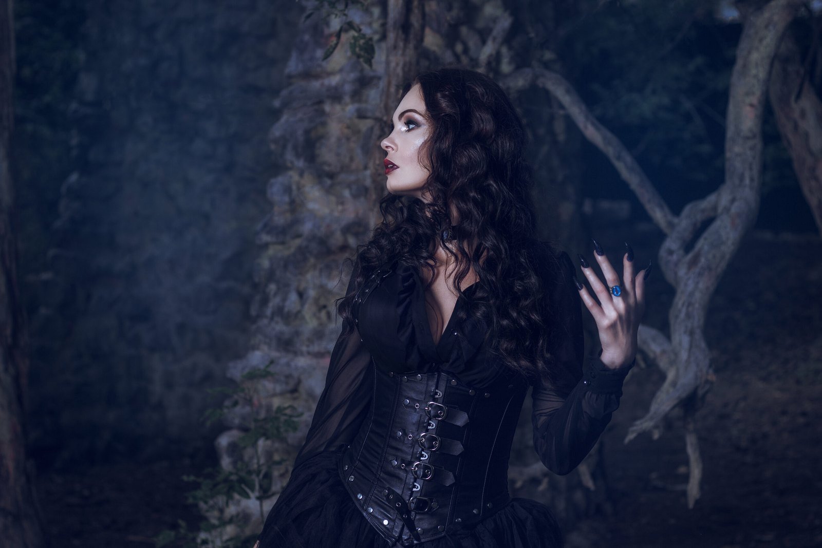 A Deep Dive into Timeless Fashion: Mysterious gothic lady in dark Victorian attire, gazing into the night with a dramatic pose.