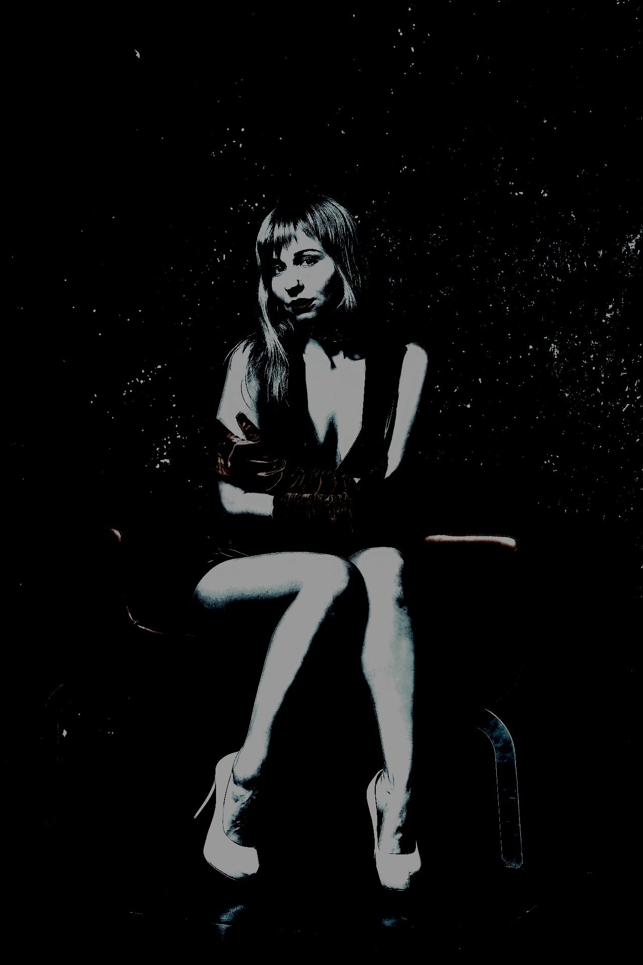 seated woman in leather attire: "Elegant woman seated in a provocative leather outfit, emphasizing the psychological dynamics of dominance and submission.