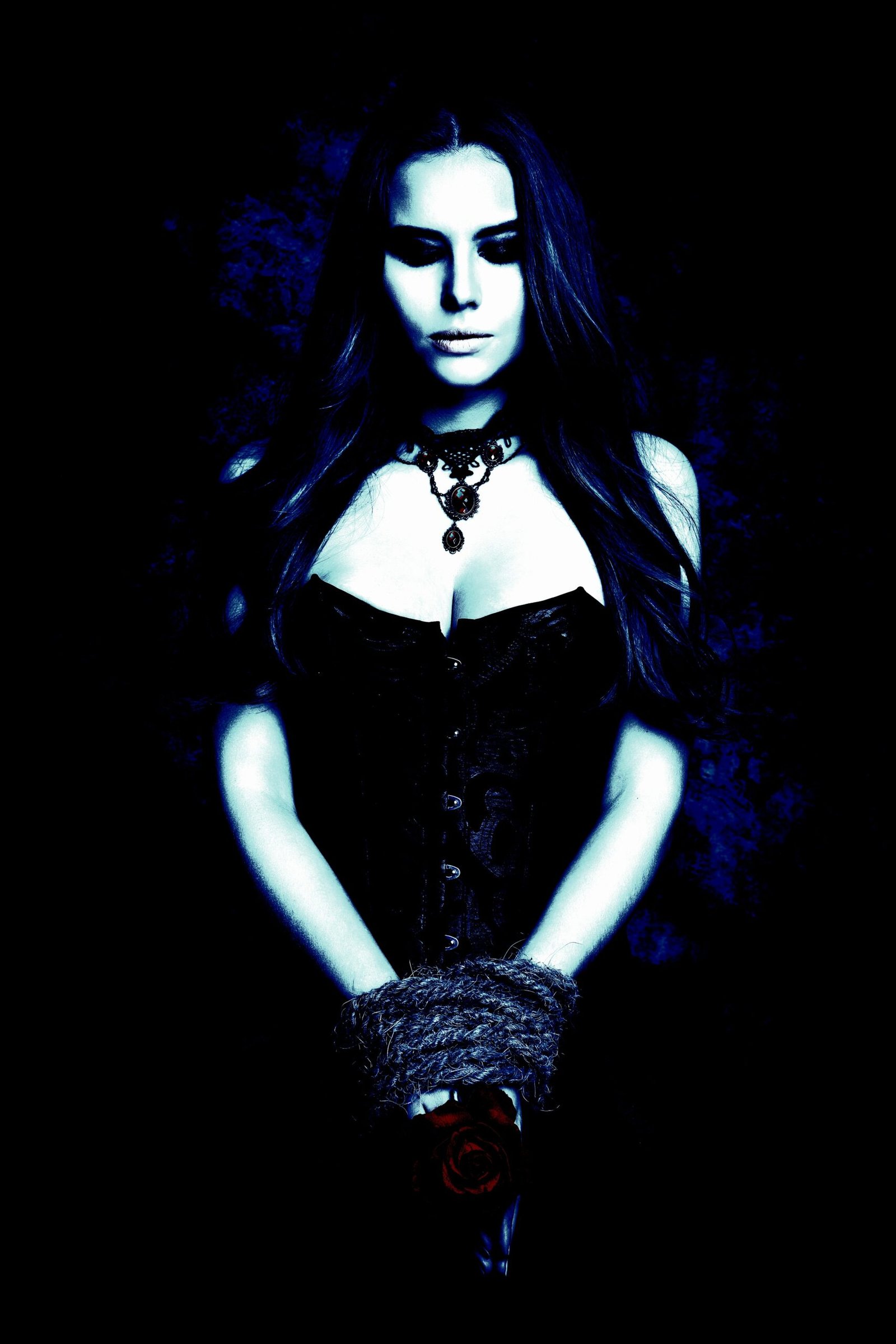 Gothic jewelry with a minimalist leather choker on a woman in a black leather jacket.