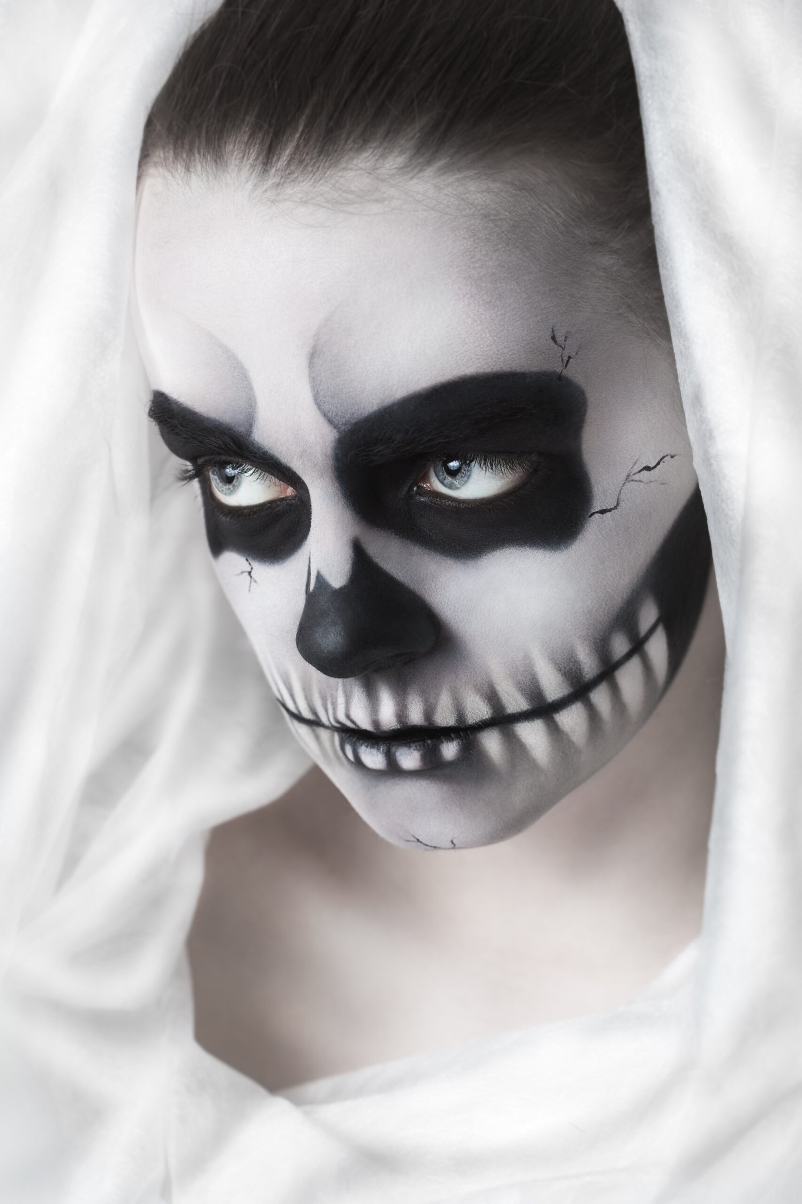 Woman with dramatic skull makeup symbolizing death, tied to Tattoos in the Metal Subculture.