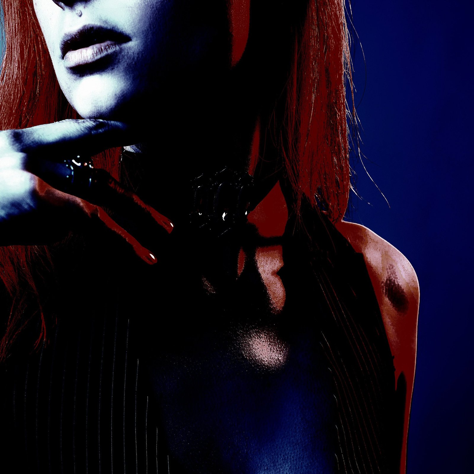 Dramatic Gothic jewelry on a woman with a chained collar necklace and dark attire.
