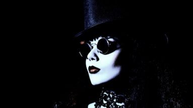 Intense gothic woman in a corset, dramatically lit to showcase the Ultimate Gothic Ensemble.