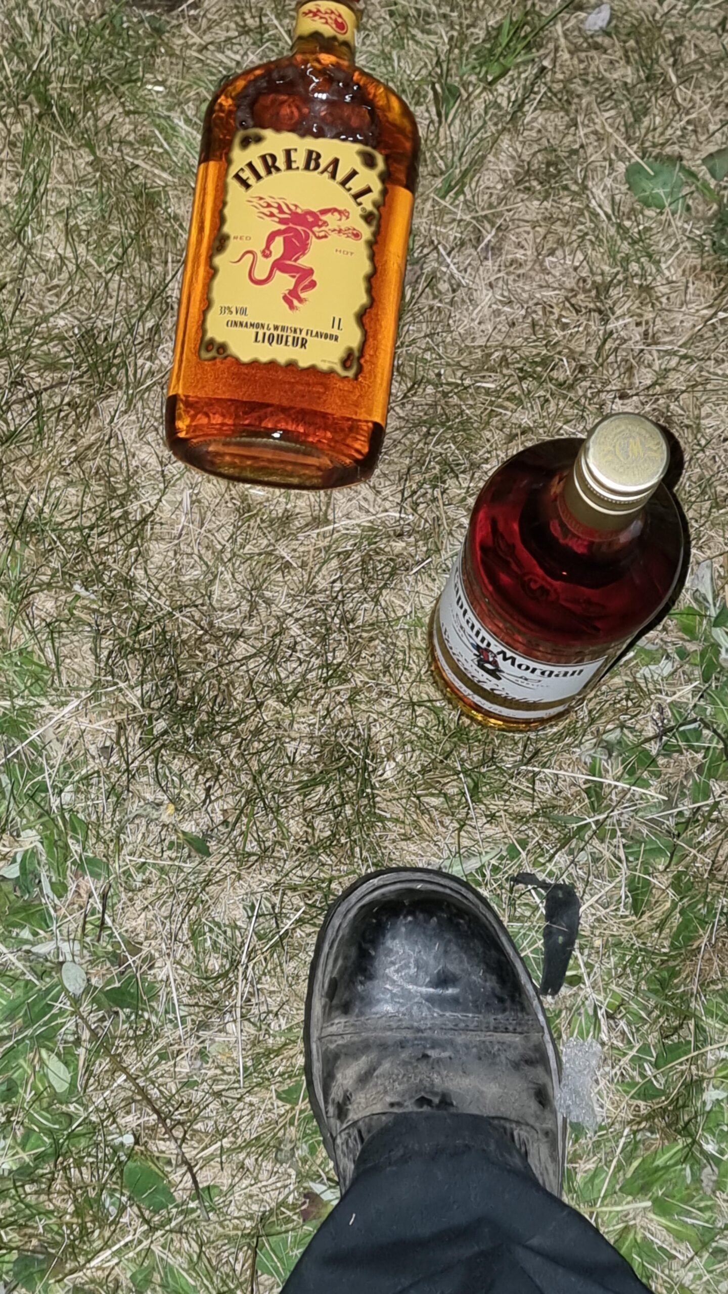 Bottles of Fireball whisky and Captain Morgan rum on the grass at Sweden Rock Festival 2024