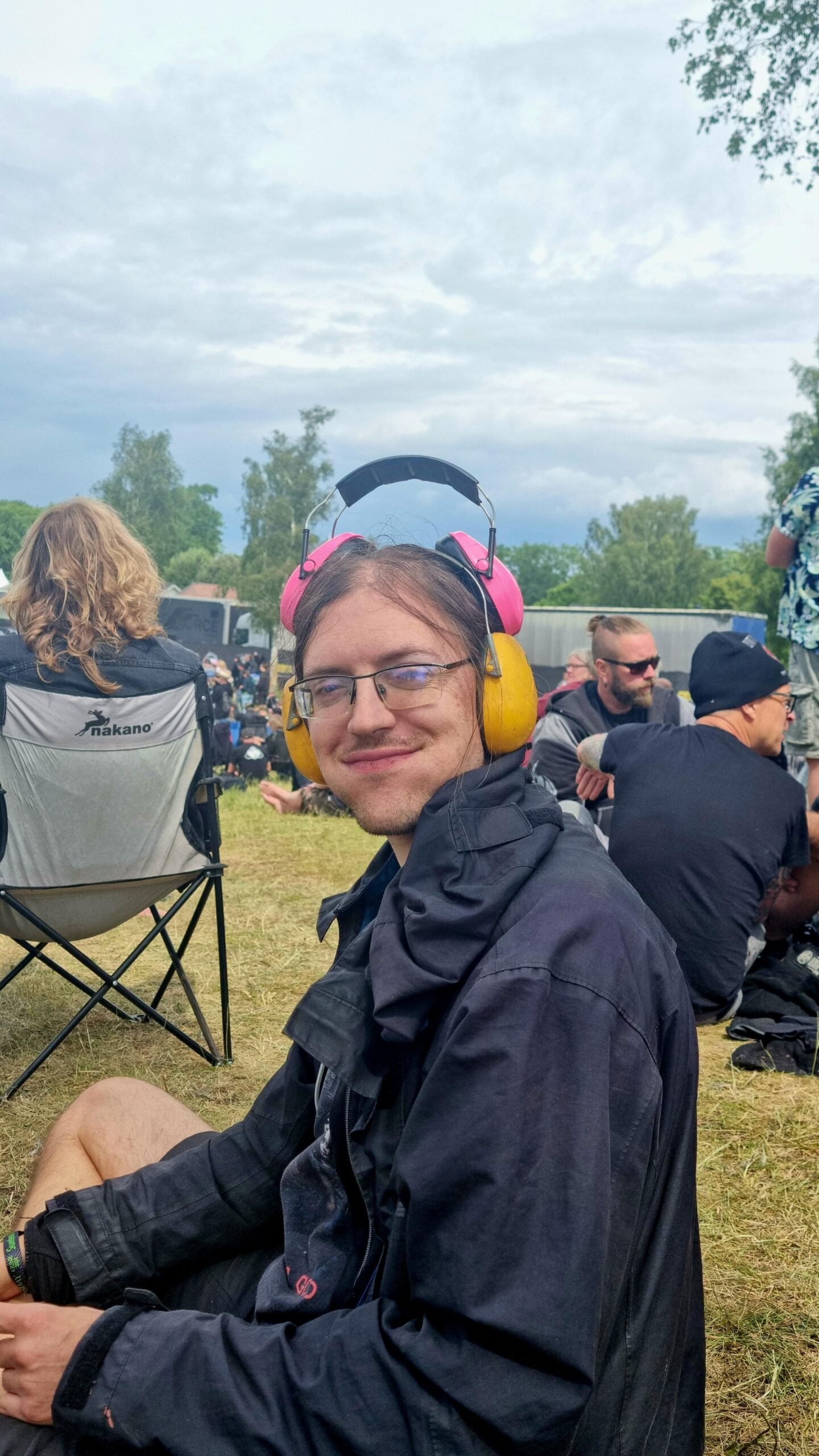 Man wearing ear protection and smiling at Sweden Rock Festival 2024