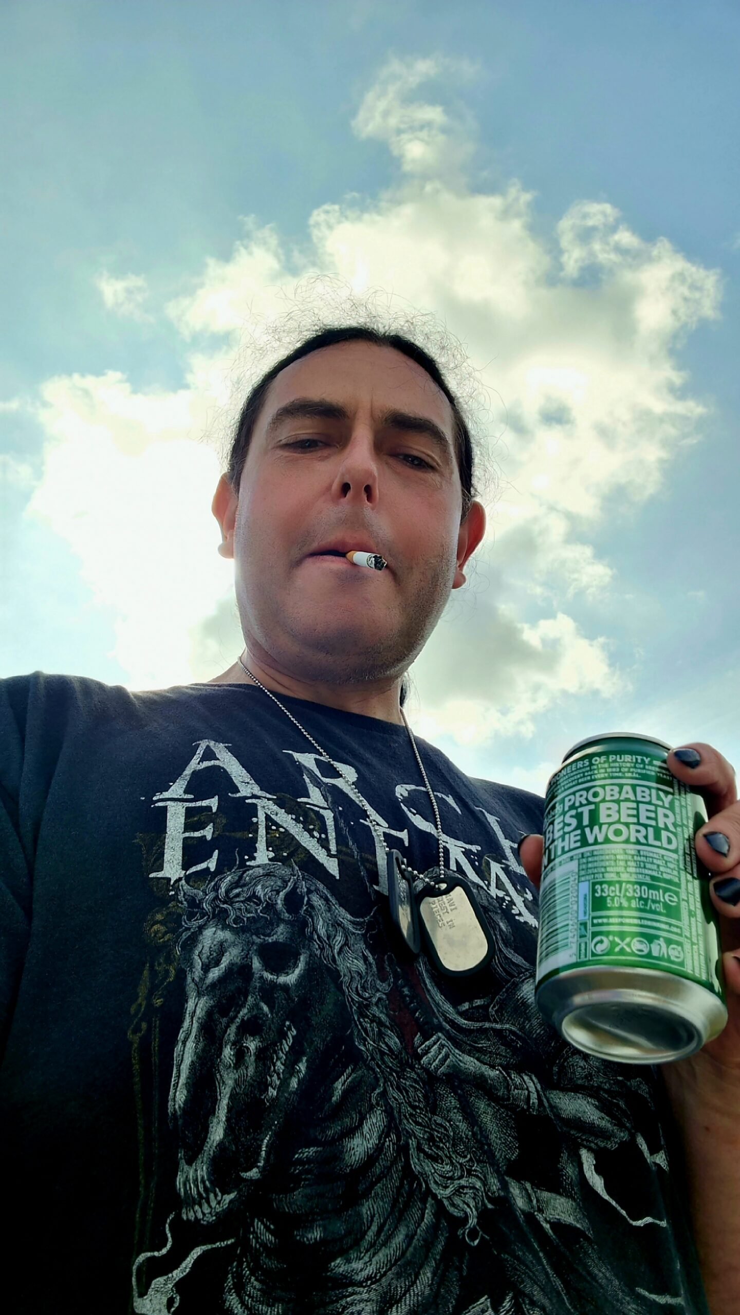 Man smoking a cigarette and holding a can of beer at Sweden Rock Festival 2024