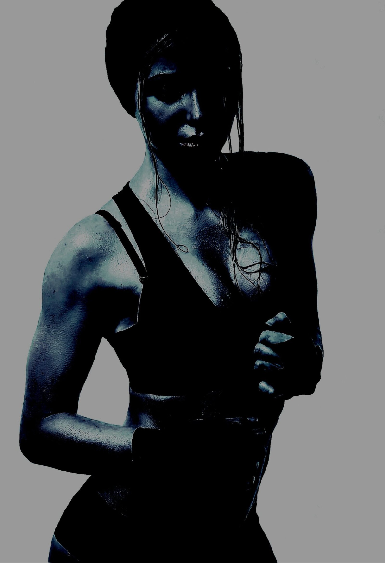 Woman posing confidently in a workout outfit, illustrating the confidence inspired by Heavy Metal Yoga
