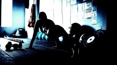 Woman performing a plank exercise, reflecting the strength and balance of Heavy Metal Yoga