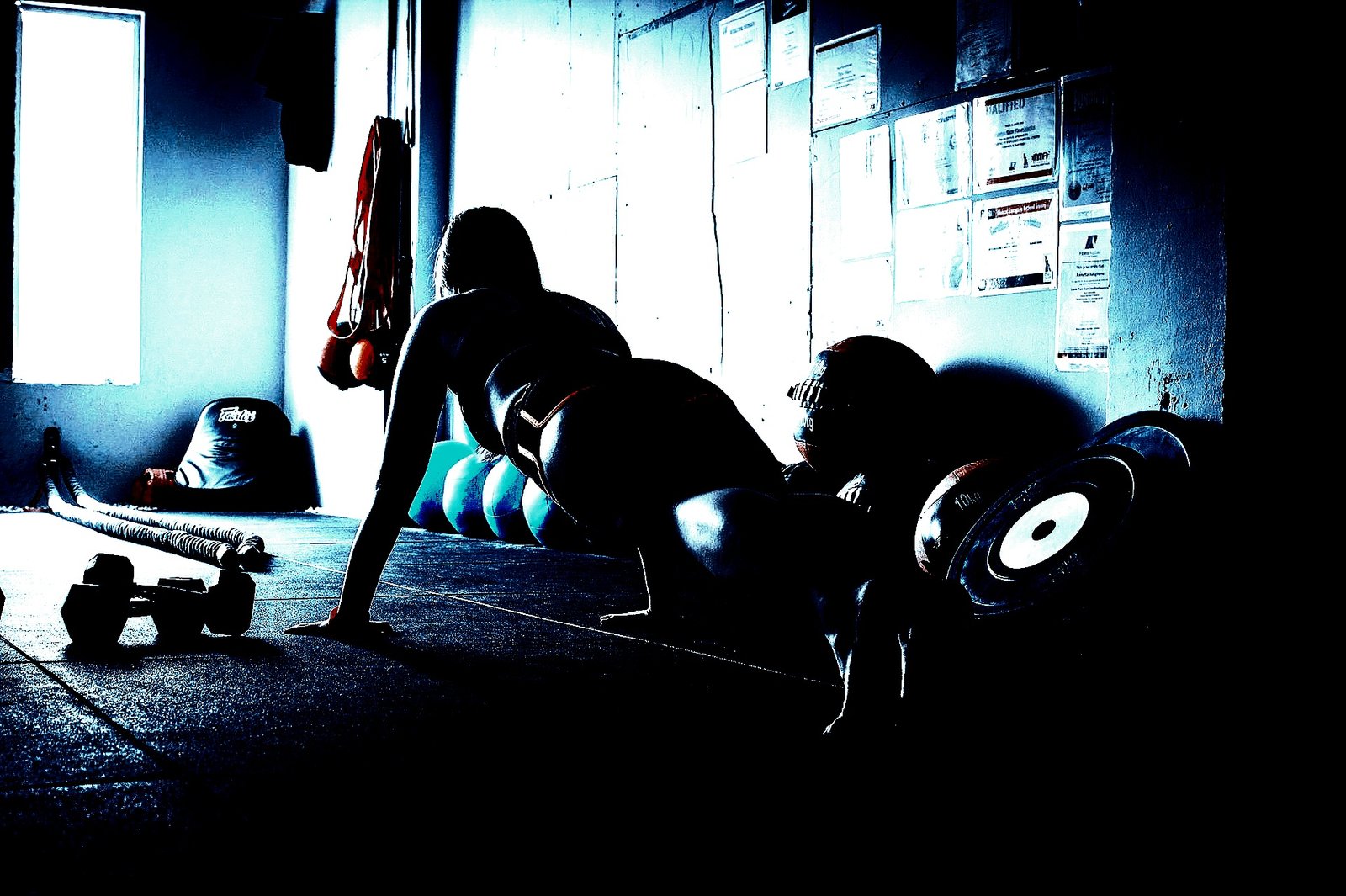 Woman performing a plank exercise, reflecting the strength and balance of Heavy Metal Yoga