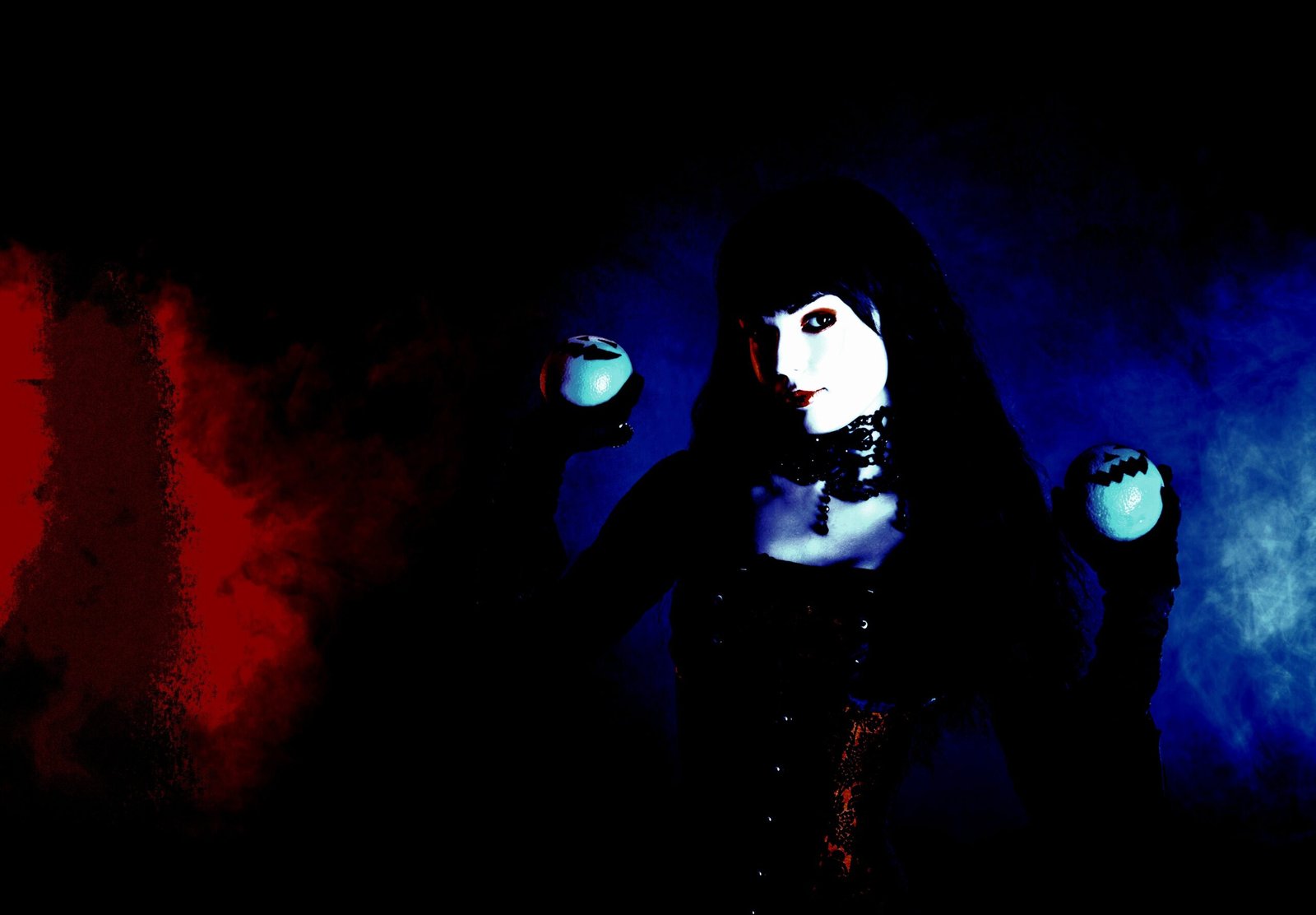 Gothic woman in a Witchy Fishnet Goth Mini Skirt Outfit holding two glowing orbs with blue and red lighting