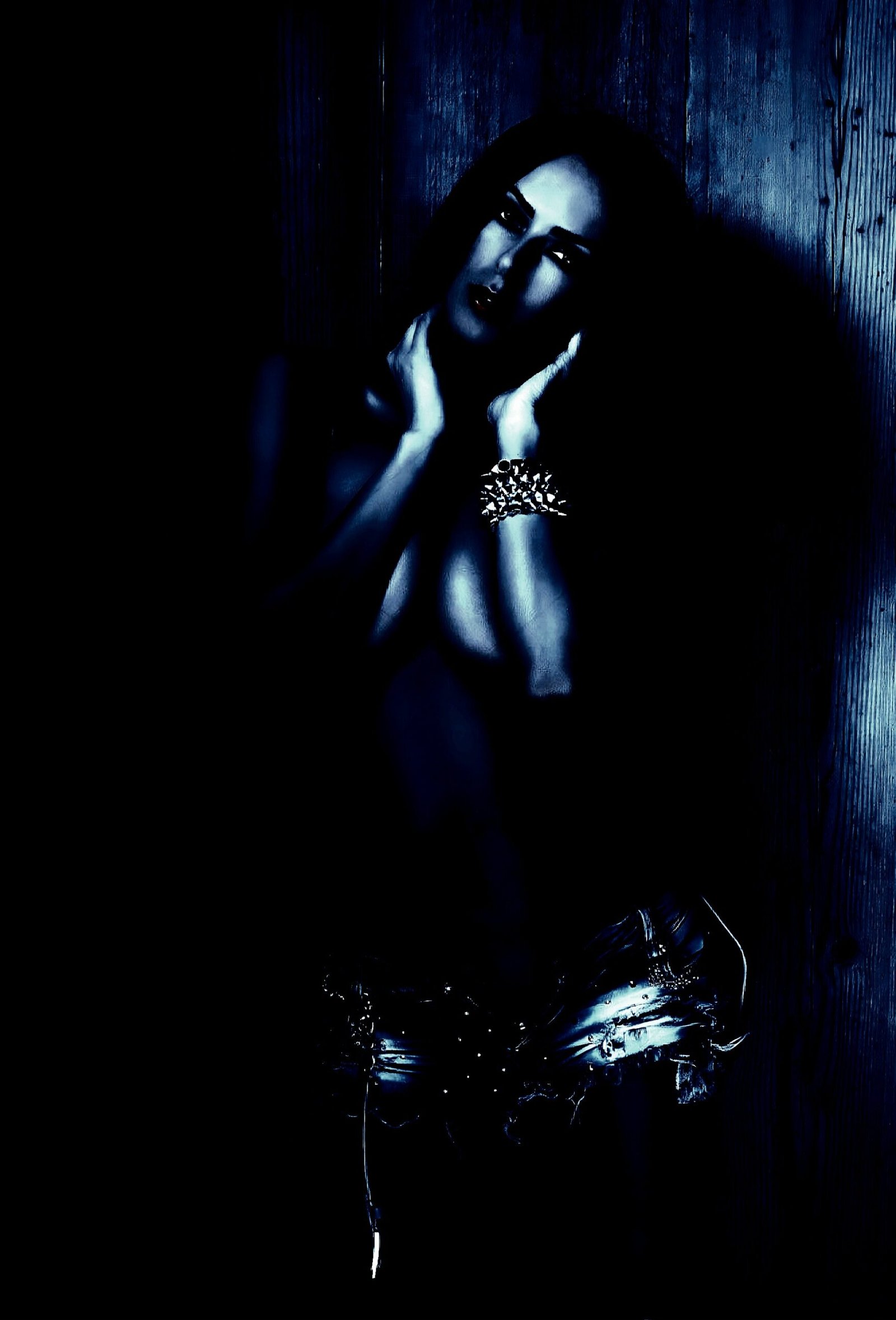 Woman with long hair in a contemplative pose, reflecting on BDSM practices.