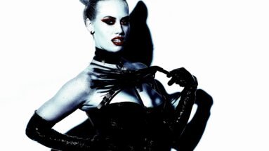 A woman in BDSM attire demonstrating the intricate dynamics of BDSM extreme pain processing, highlighting the psychological and emotional aspects of pain.