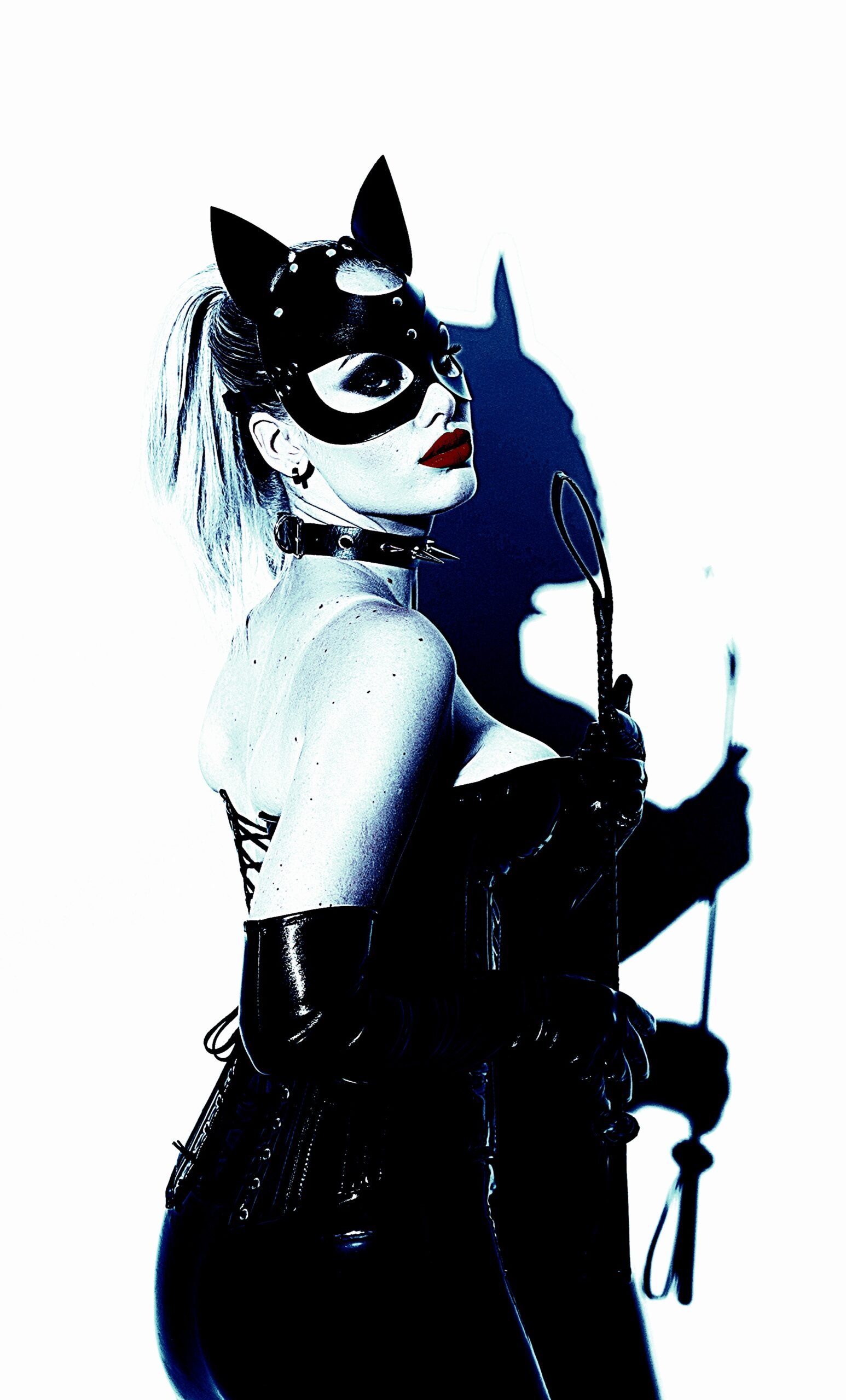 A woman in a BDSM cat mask and corset, representing the power dynamics and consensual aspects of extreme pain in BDSM.