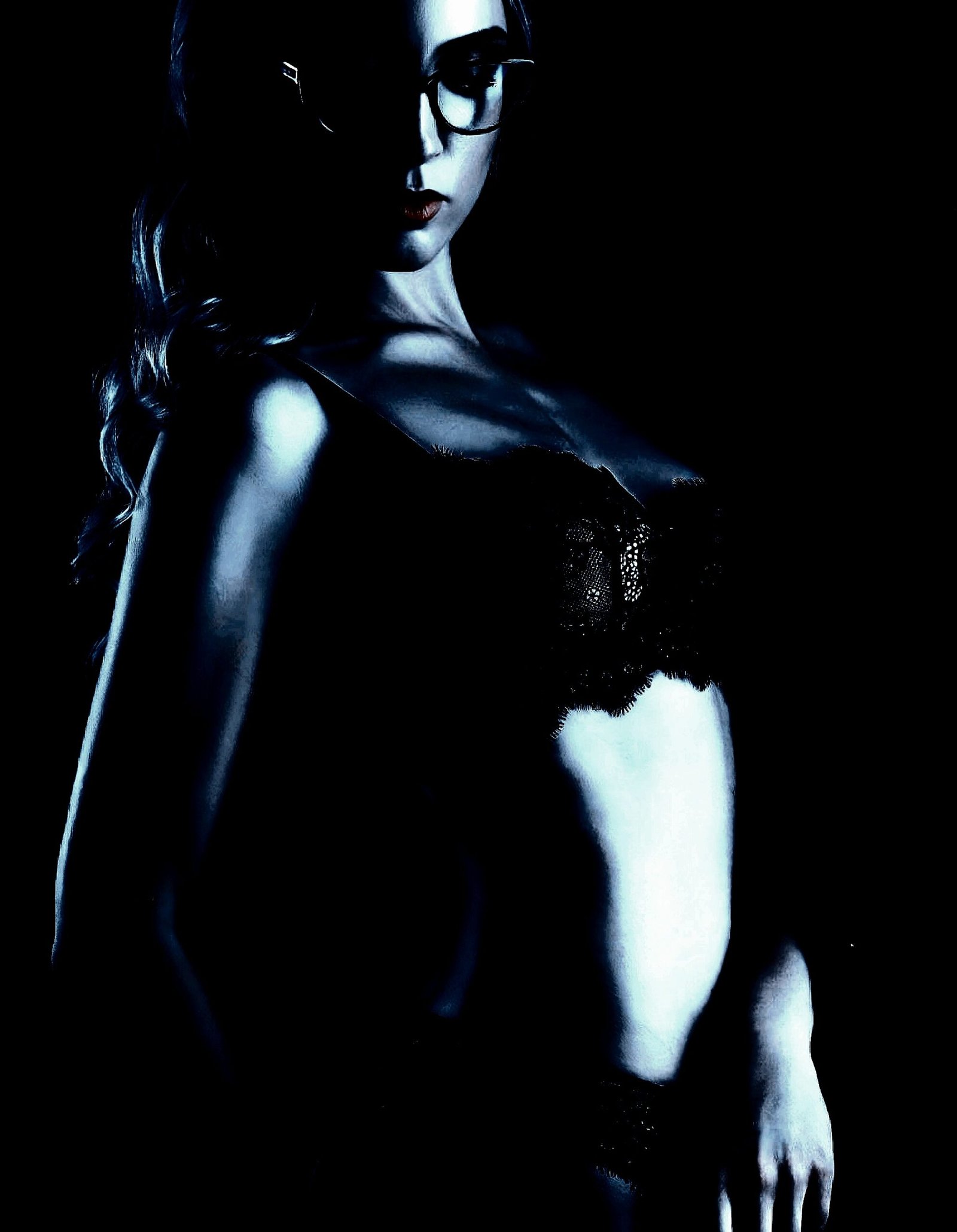 Stylish woman in glasses and lingerie, embracing the confidence of BDSM practices.