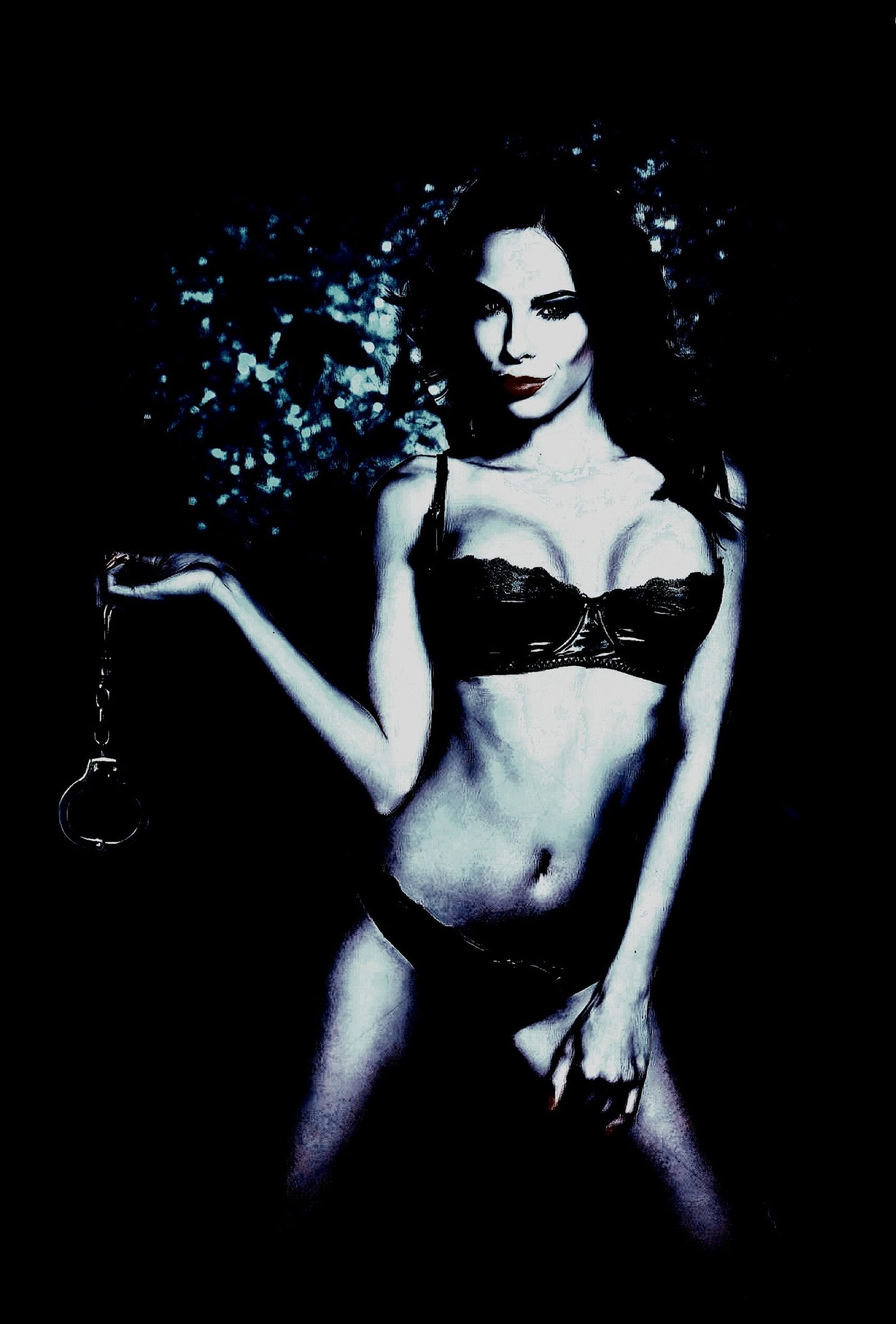 An intimate moment between a shirtless man and a woman in lingerie, both sharing a playful and affectionate exchange.