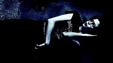 Alternative fashion model lying on the ground wearing an Iron Maiden T-shirt.