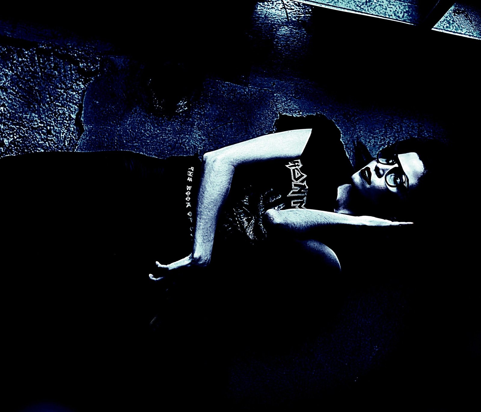 Alternative fashion model lying on the ground wearing an Iron Maiden T-shirt.