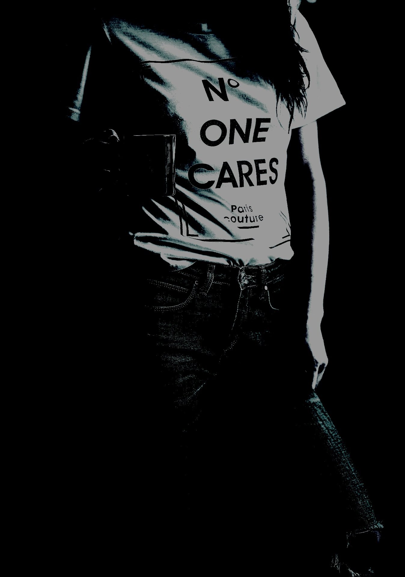 Person wearing a 'No One Cares' T-shirt and jeans in a dark environment.