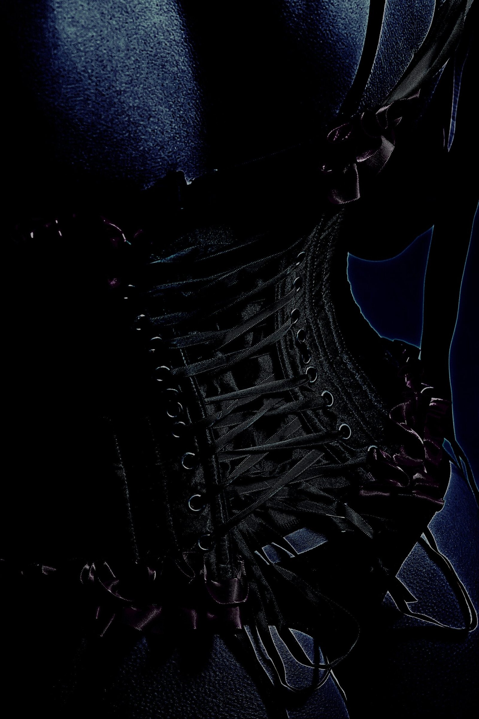 Close-up of a black corset with intricate lacing and dark, gothic aesthetic.