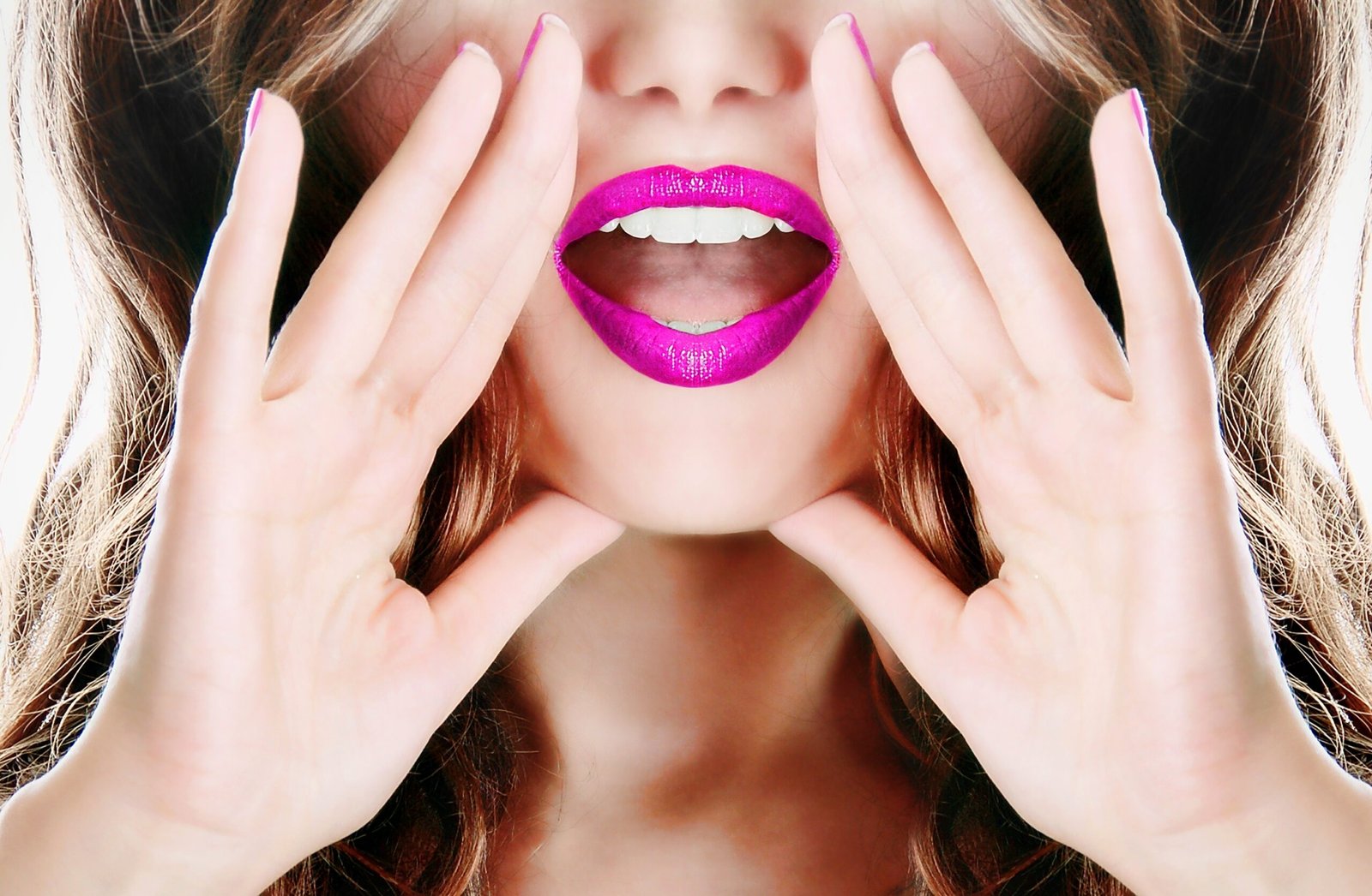 Close-up of a woman's bright pink lips, hands cupped around her mouth, shouting or calling out.
