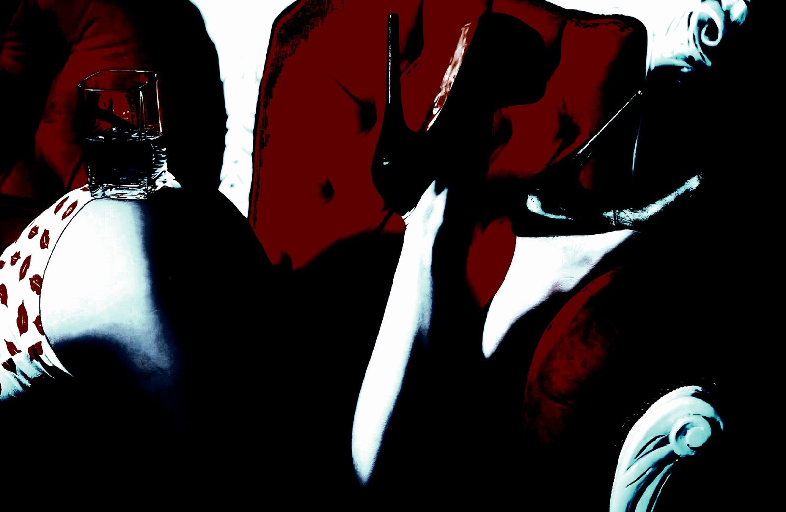 Artistic image of a person lounging on a red sofa with a glass on their hip and high heels visible.
