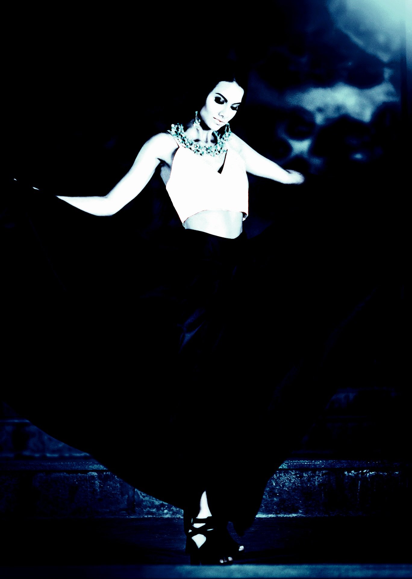 Fashionable woman in a flowing dark dress and gothic jewelry, illustrating the Vampire Halloween Costume Aesthetic.
