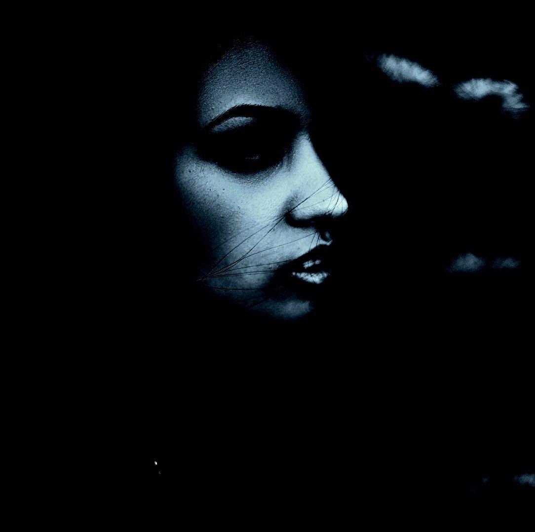 Mysterious female portrait with dark makeup and shadows, highlighting the Vampire Halloween Costume Aesthetic.