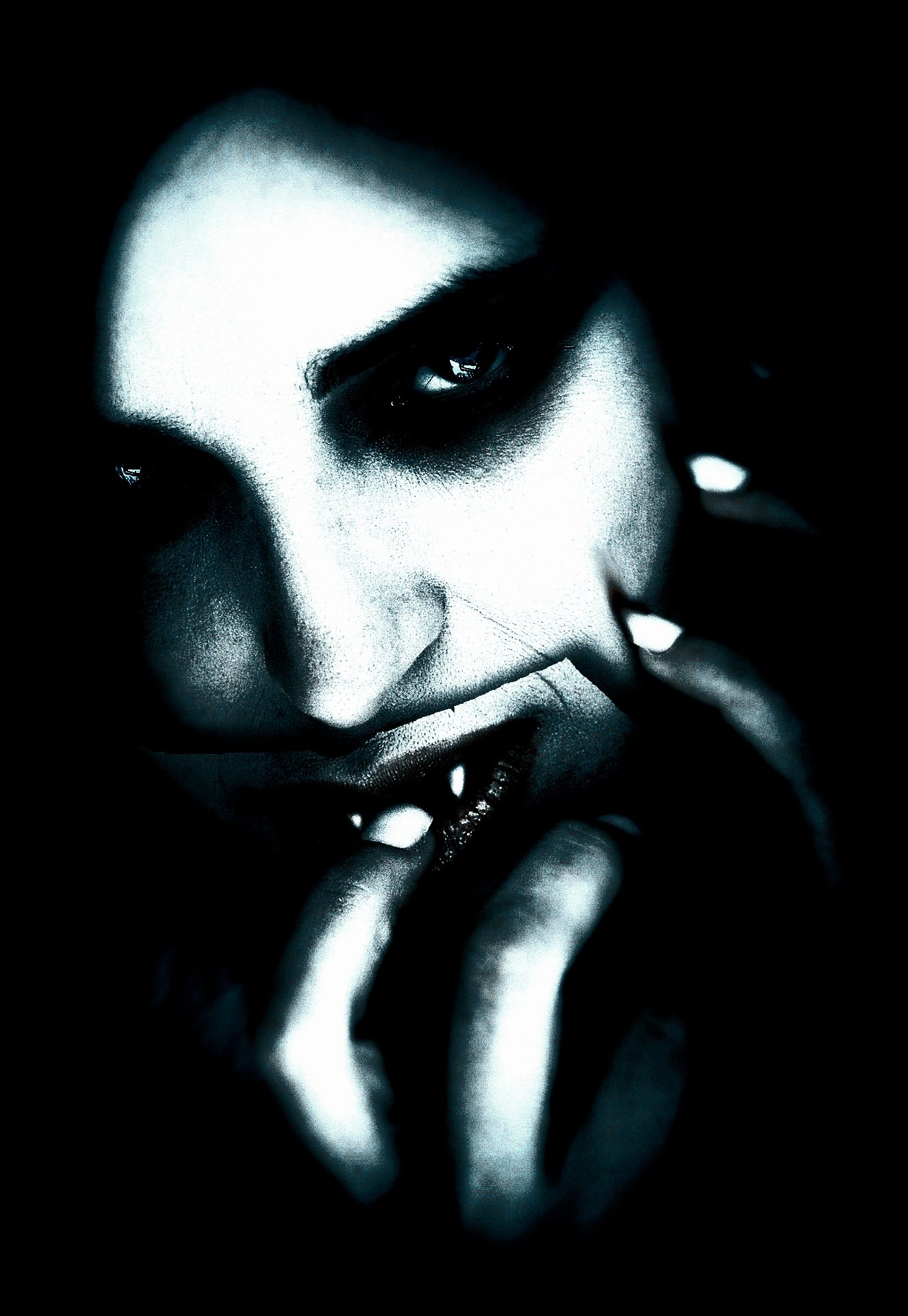 Close-up of a sinister face with dark makeup and fangs, capturing the eerie Vampire Halloween Costume Aesthetic.
