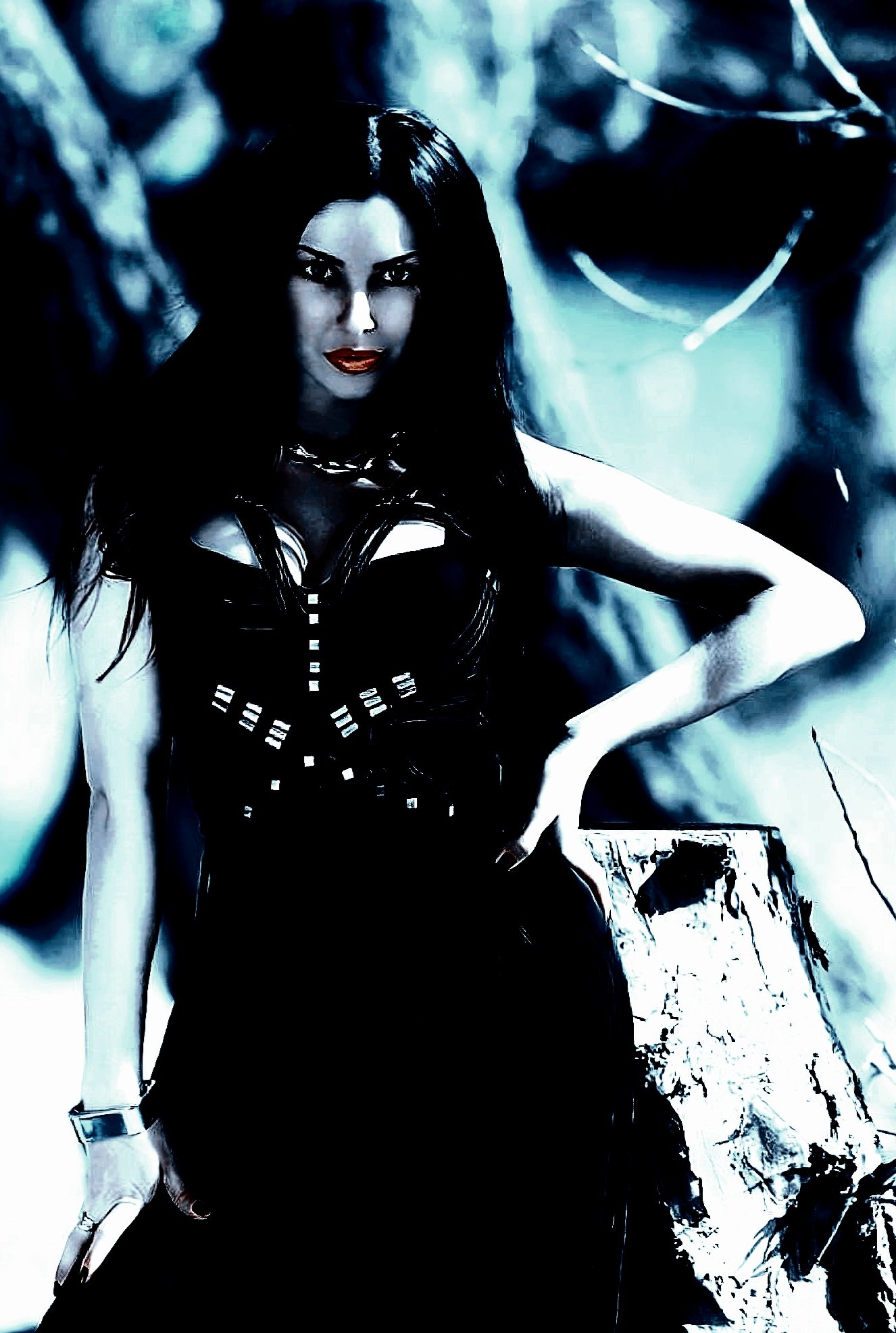 A woman in a gothic black dress standing confidently outdoors, her dark hair flowing, with a piercing gaze against a blurred forest background.