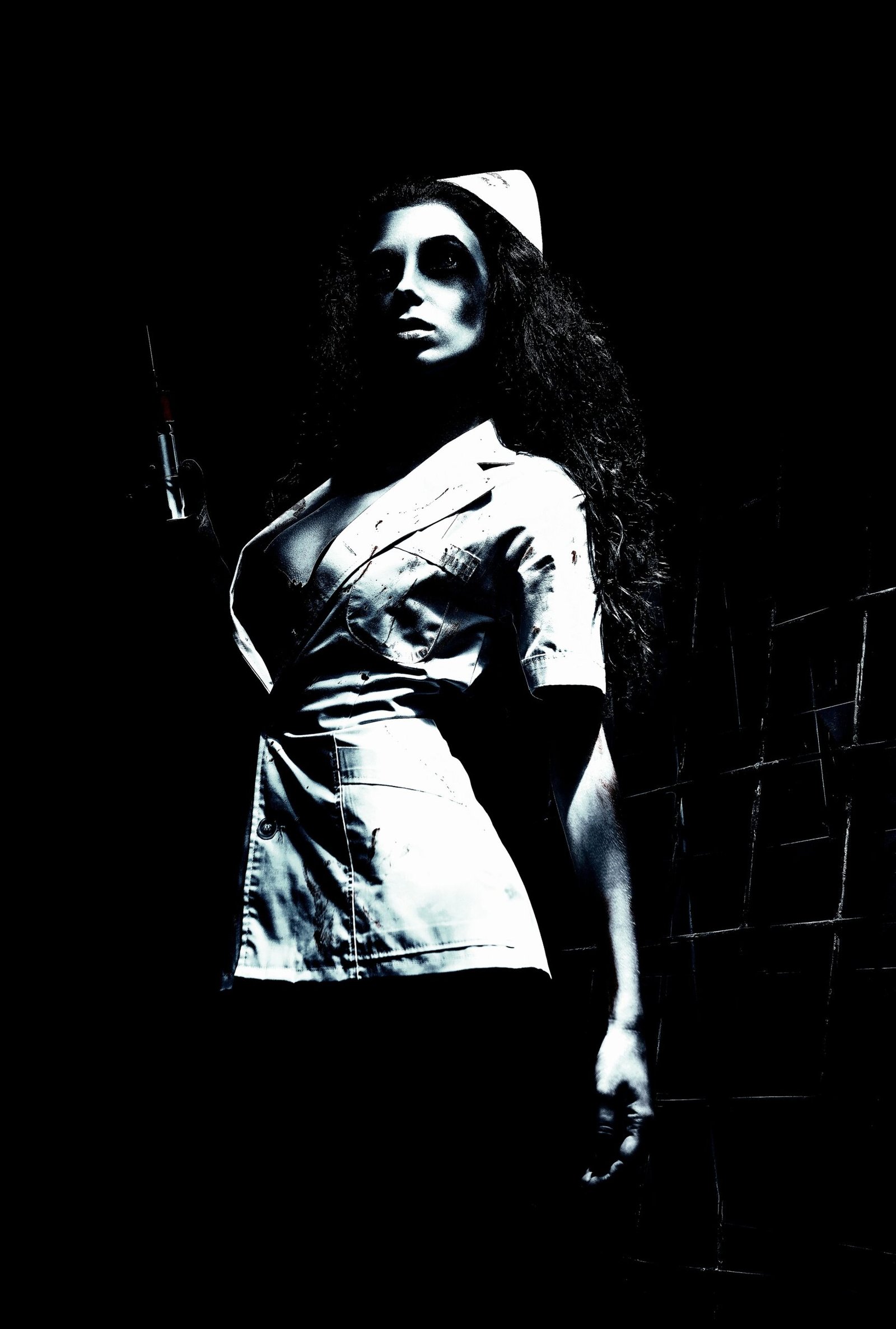 A shadowy figure of a woman partially obscured by a doorway, wearing a t-shirt, her features bathed in darkness, evoking a sense of mystery.
