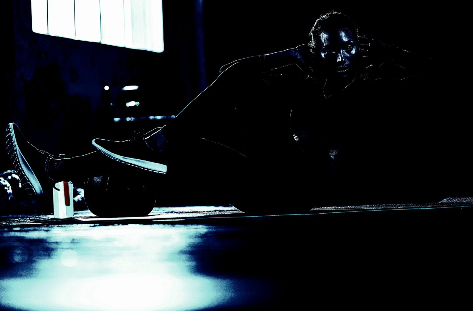 Athlete performing sit-ups in a darkened gym, reflecting determination and the solitary nature of personal fitness training.