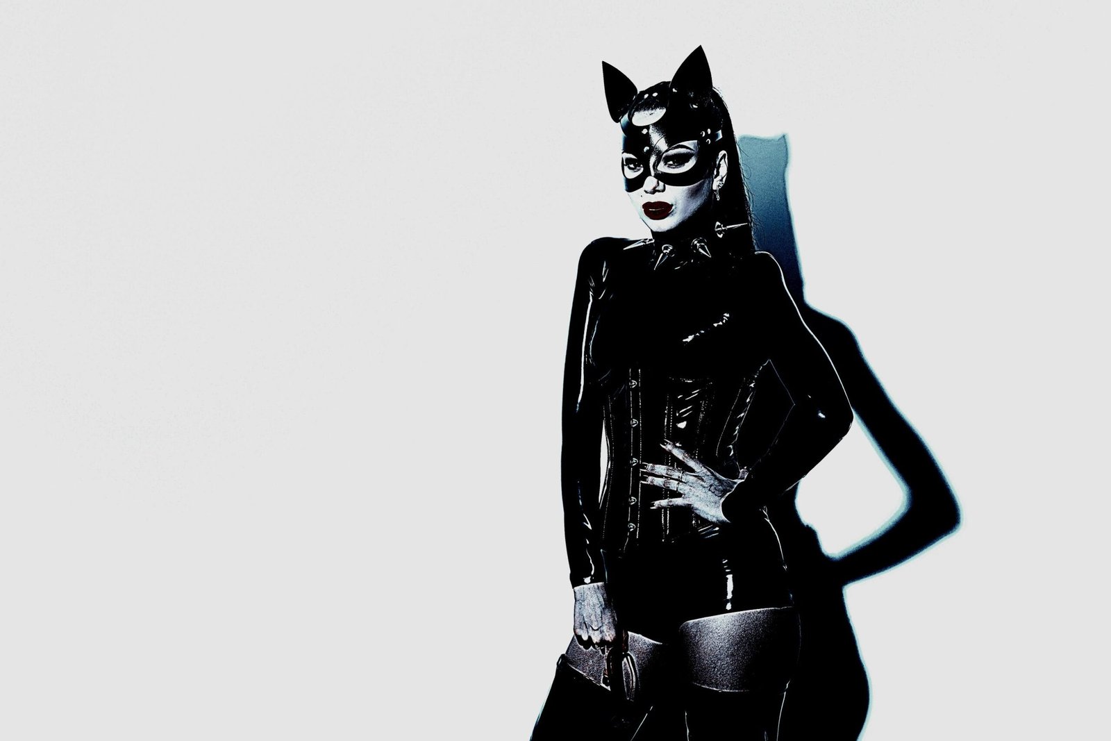 Gothic cosplay featuring a femme version of Catwoman in a sleek black latex suit and mask, embodying a bold and sensual aesthetic.