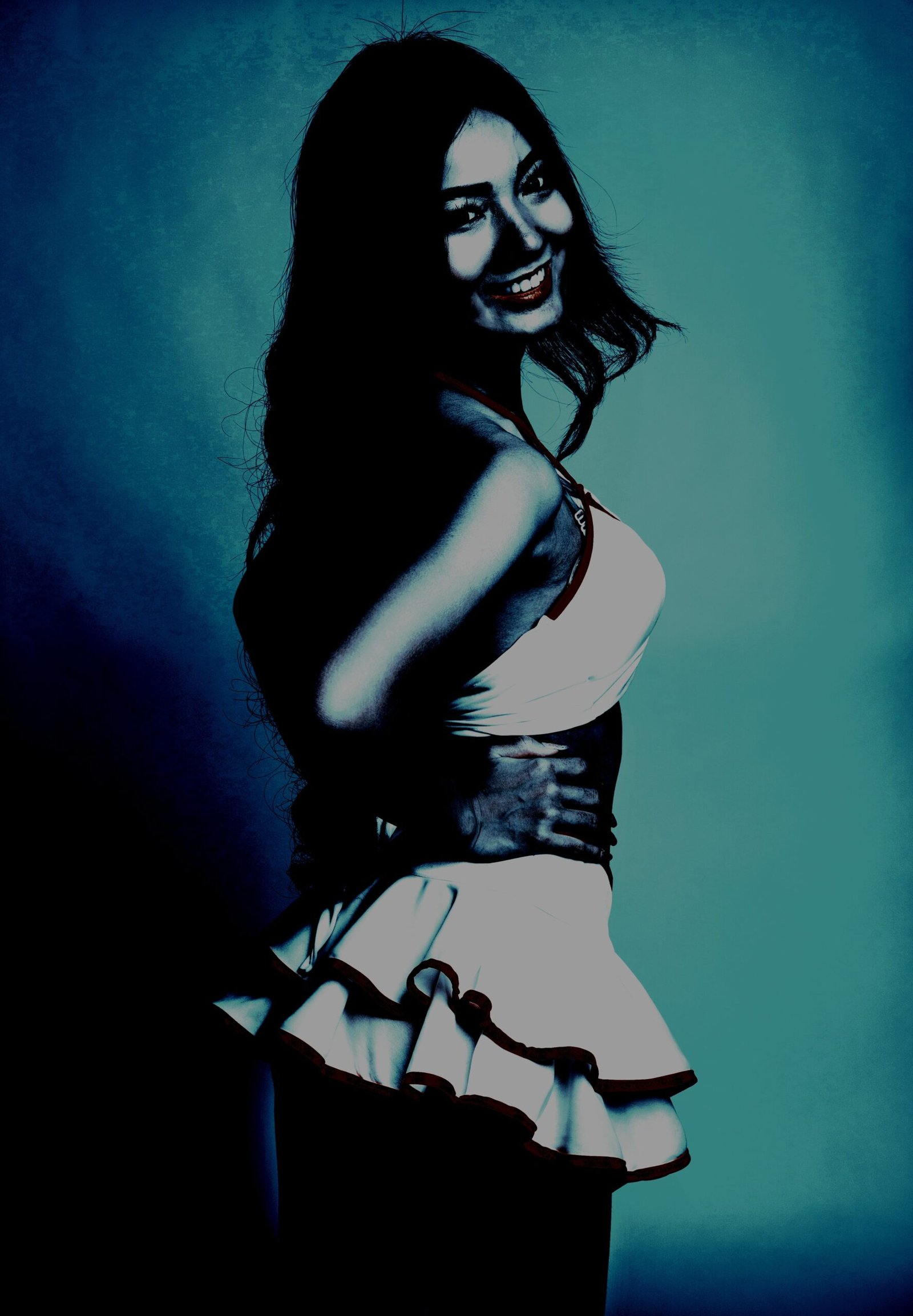 Alternative cosplay of a playful and seductive character in a white dress, smiling against a moody teal backdrop. 