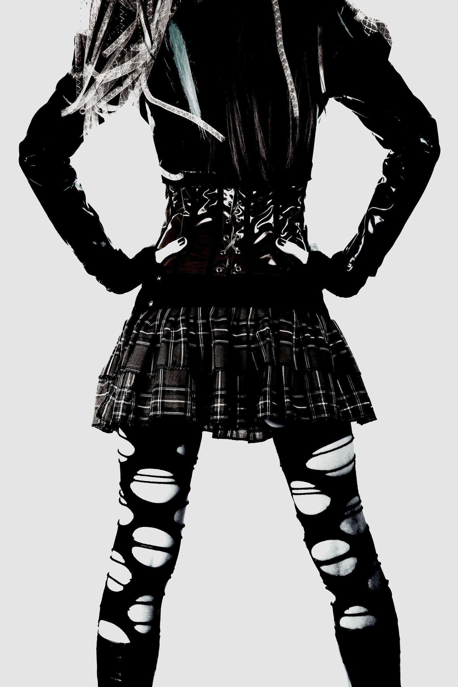 Punk-inspired latex corset with a plaid skirt and torn leggings, showcasing an alternative rebellious style.