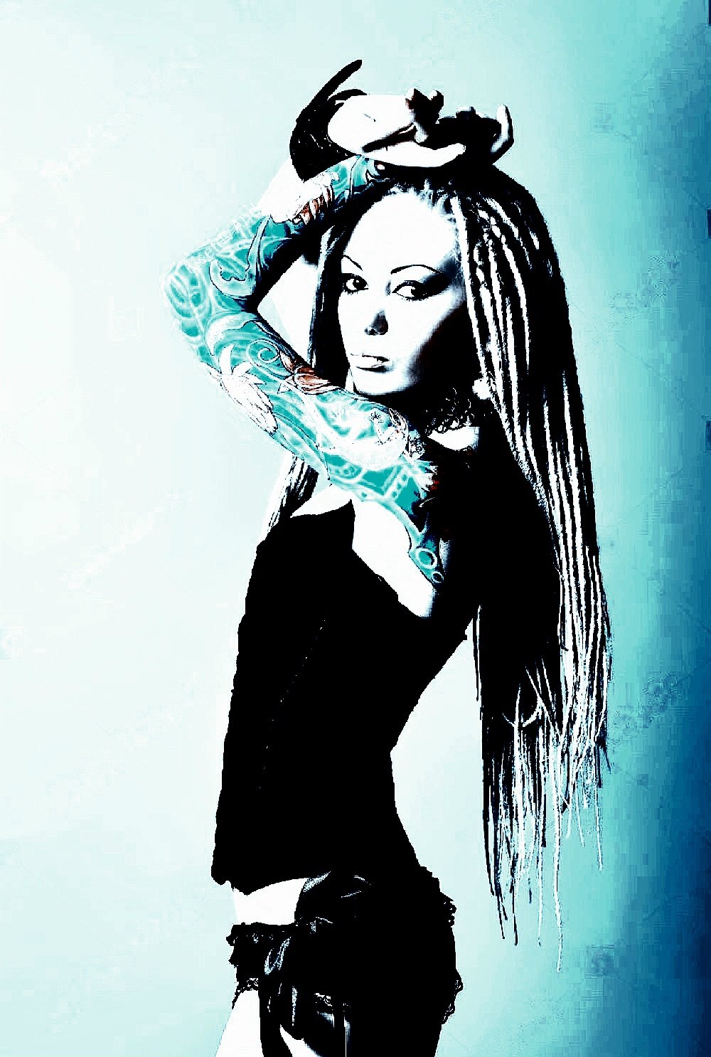 Stylish gothic woman with white dreadlocks and intricate arm tattoos, wearing black lingerie in a striking pose.