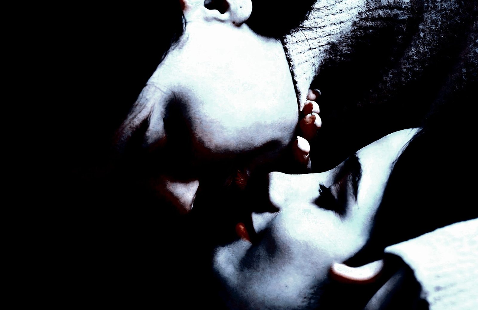 Two individuals sharing an intimate kiss, capturing a moment of closeness and tenderness.