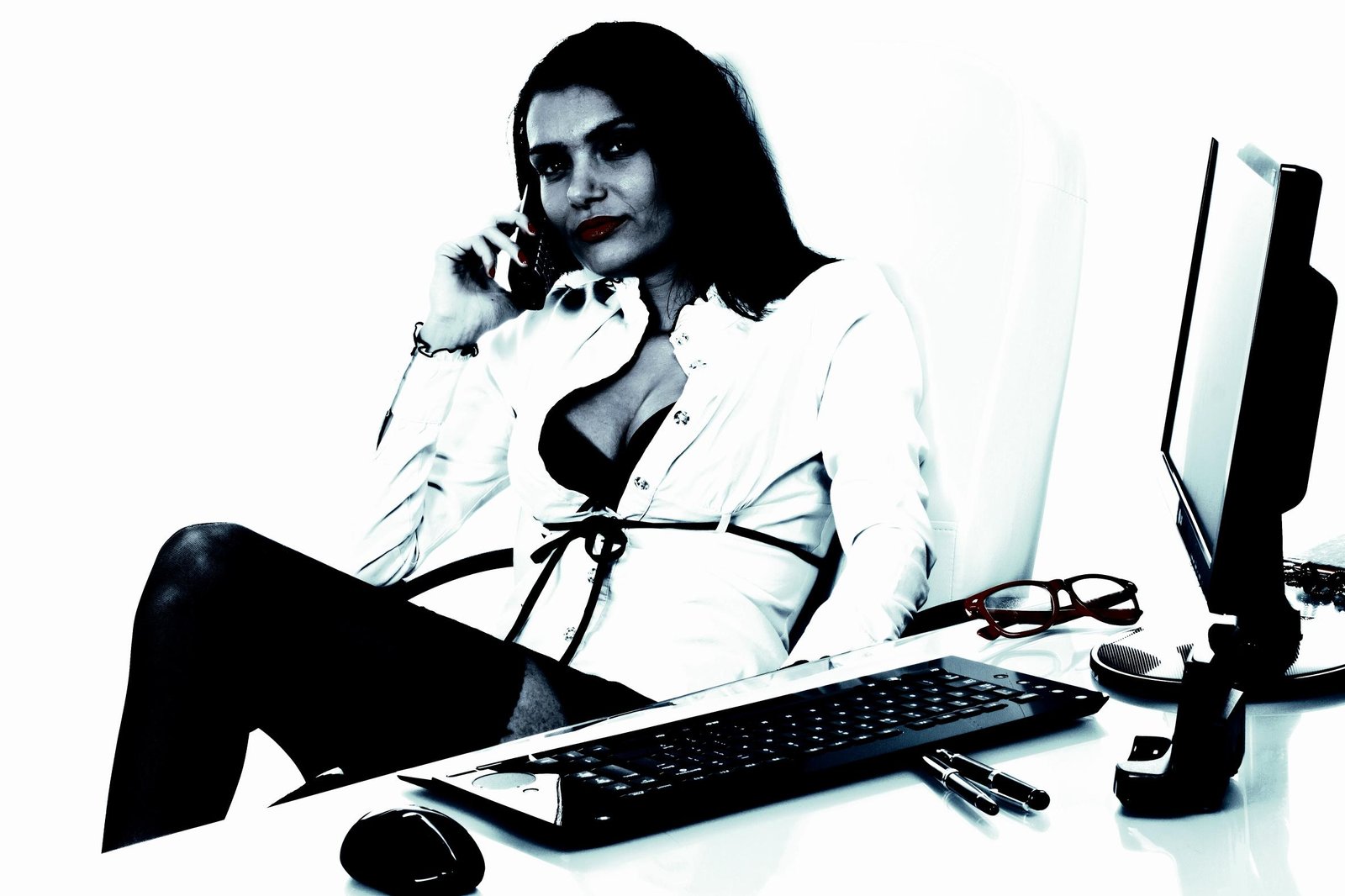 Woman in a white blouse, speaking on the phone at her desk, surrounded by office supplies, with a bold and striking aesthetic.