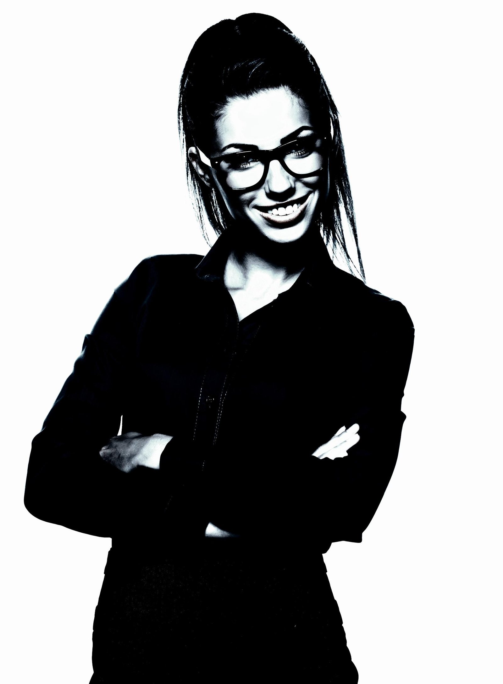 Smiling woman in glasses and a black blouse, arms crossed confidently, exuding a professional and approachable vibe.