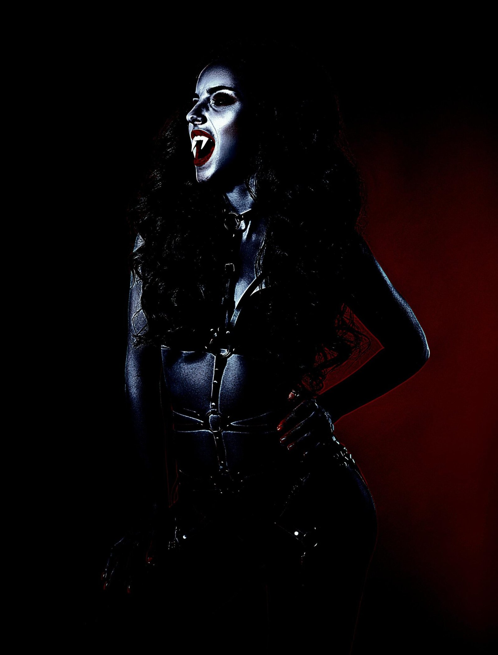 Gothic-inspired woman with vampiric makeup and fangs, dressed in a black leather harness, standing against a dark red and black background.
