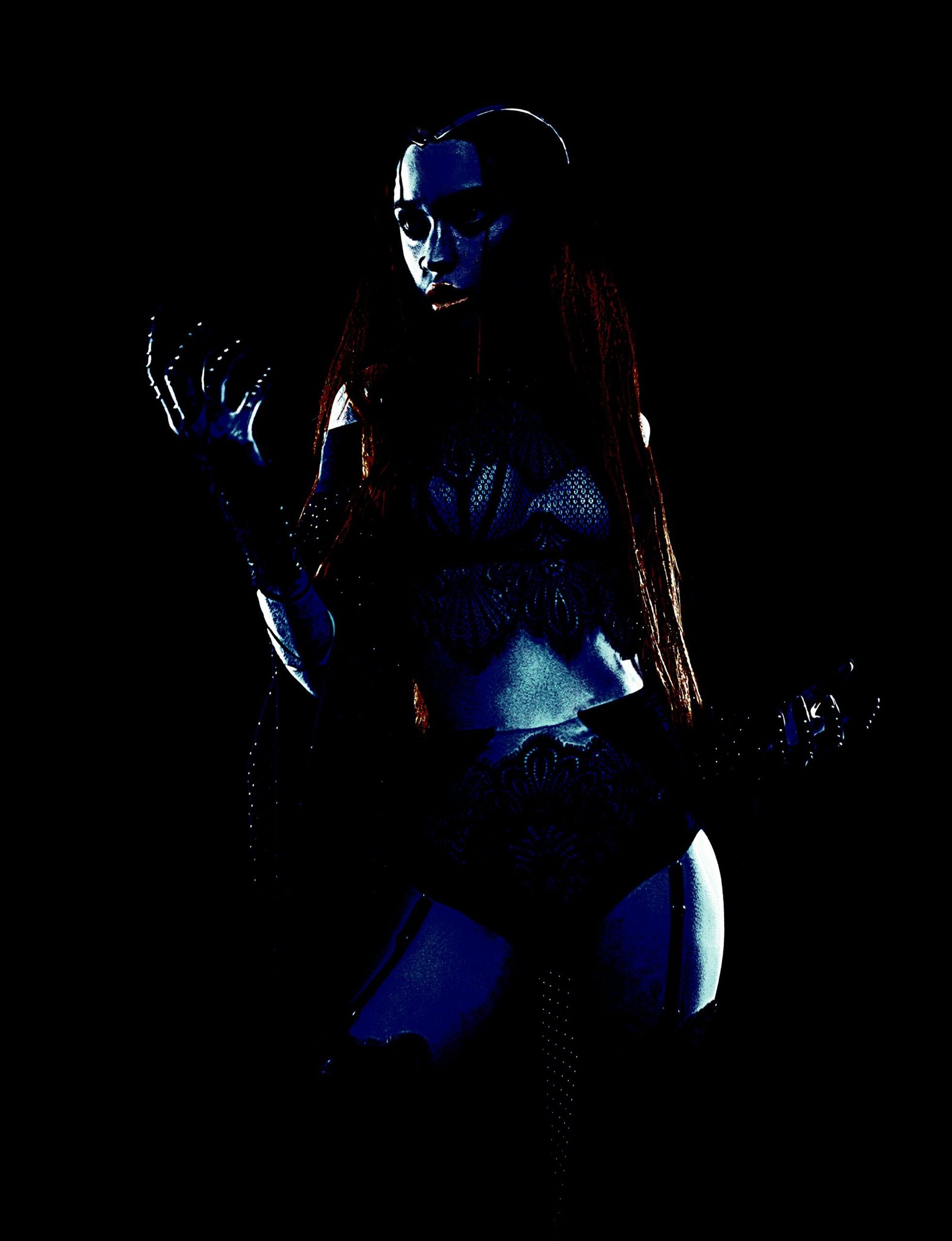 A gothic woman in intricate dark lace, standing in shadow, her expression intense and otherworldly with blue-tinted lighting.