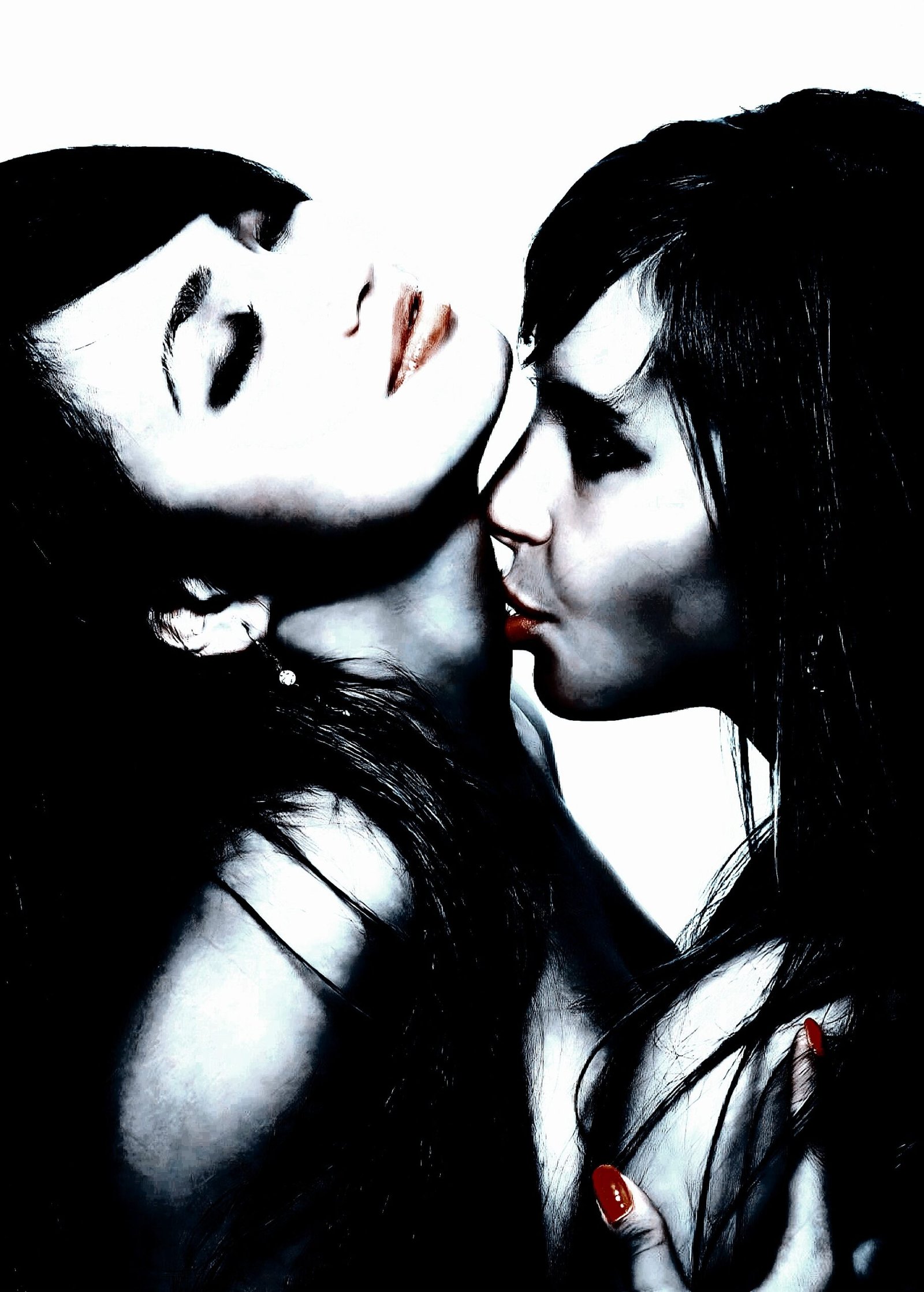 Two women kissing passionately with gothic aesthetics, wearing dark makeup and accessories.